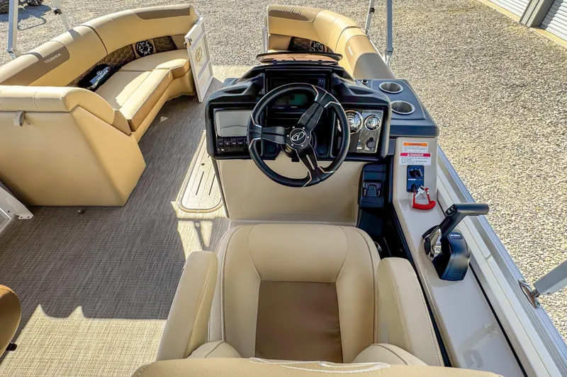 Slide: The Image of Interior of 2026 Veranda VR235L boat with beige seating and modern dashboard. - 15