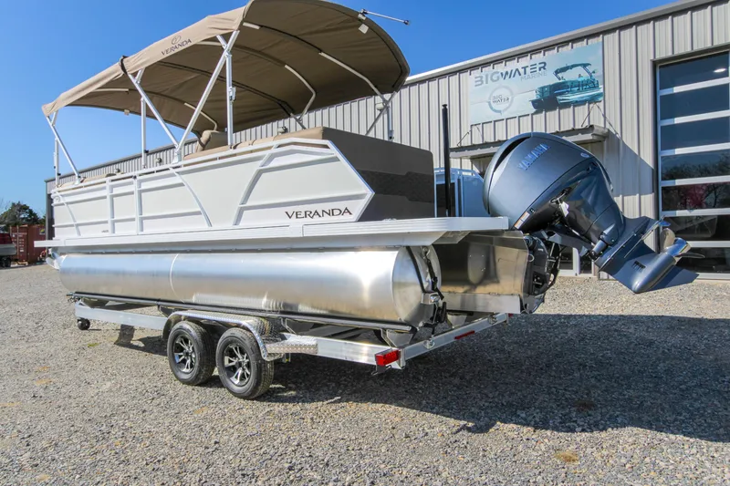Slide: The Image of 2026 Veranda VR235L pontoon boat with Yamaha outboard motor, parked outside a marine dealership. - 16