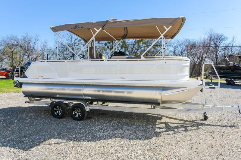 Slide: The Image of 2026 Veranda VR235L pontoon boat with canopy on a trailer, parked outdoors. - 6