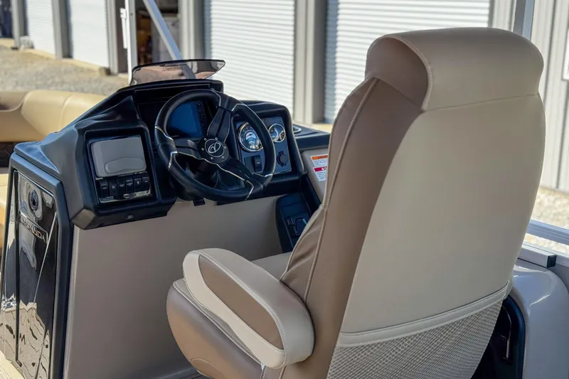 Slide: The Image of Captain's chair and helm of 2026 Veranda VR235L boat, featuring modern controls and steering wheel. - 7