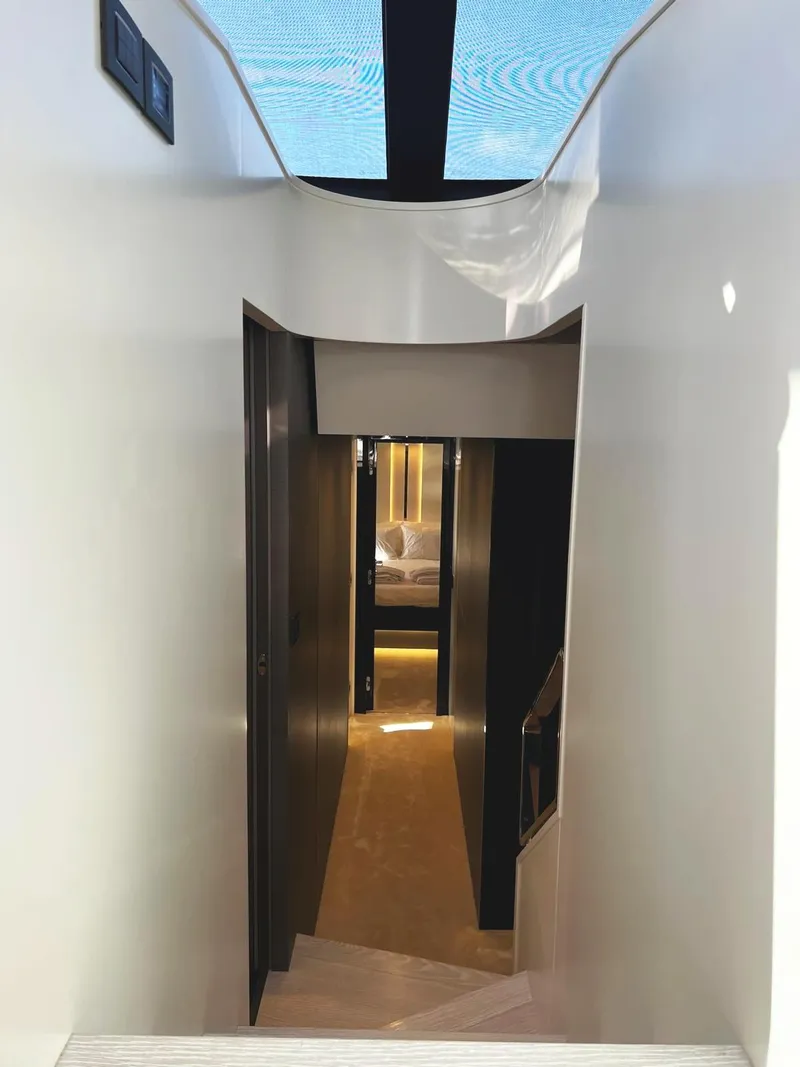 Slide: The Image of Interior hallway of 2023 Azimut S8 yacht, featuring sleek modern design and ambient lighting. - 46