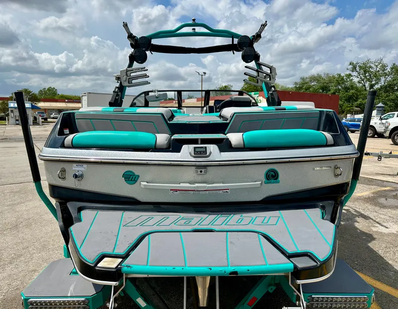Slide: The Image of Rear view of a 2022 Malibu Wakesetter 23 LSV boat in a parking lot. - 5