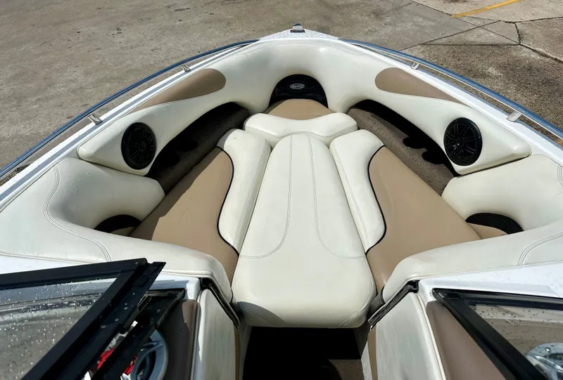 Slide: The Image of Interior of 2005 Malibu Sunscape 23 LSV boat with beige and white seating. - 12