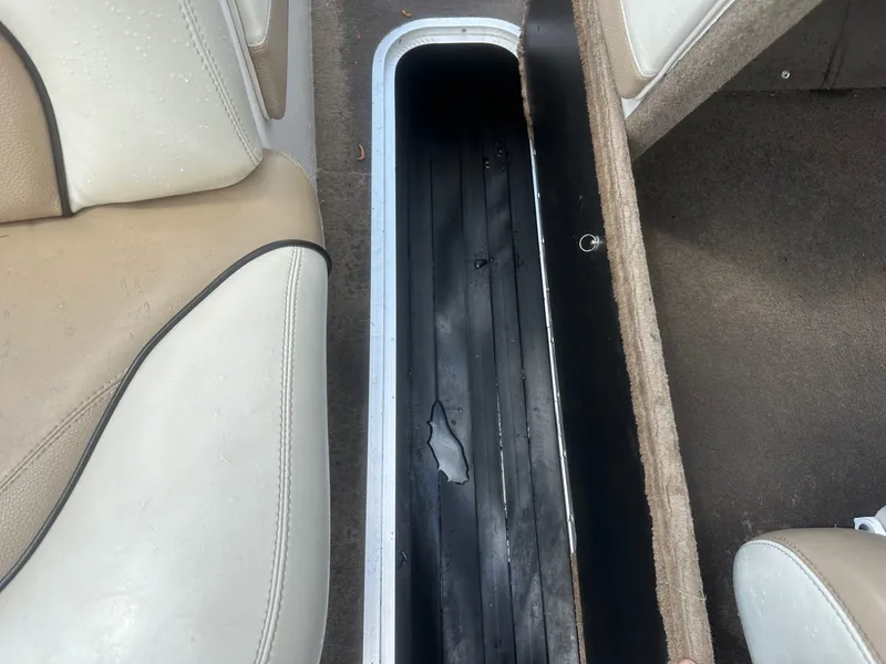 Slide: The Image of Interior of a 2005 Malibu Sunscape 23 LSV with open storage compartment. - 13