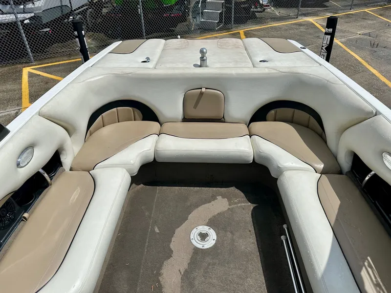 Slide: The Image of Interior of a 2005 Malibu Sunscape 23 LSV boat with beige seating. - 20
