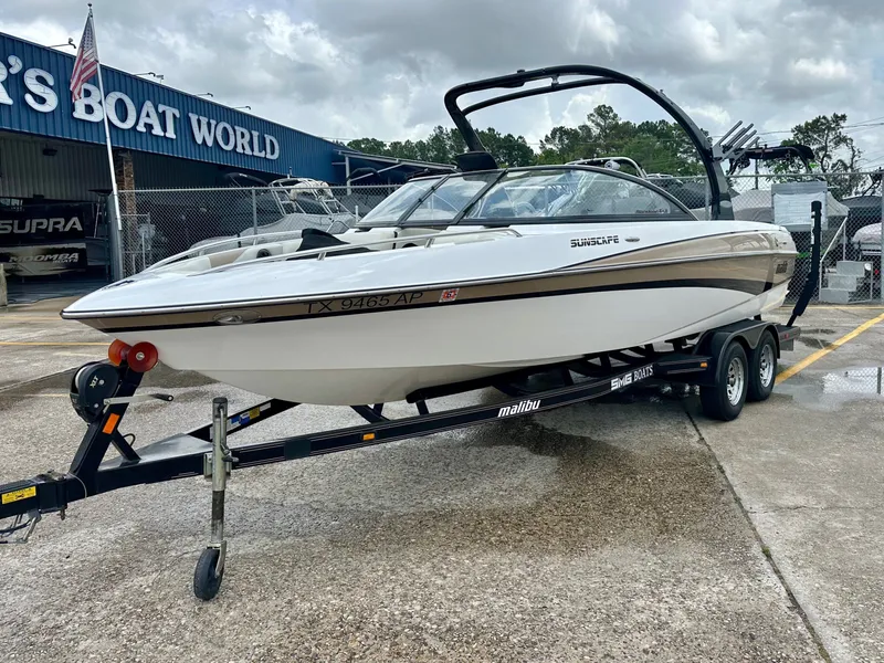 Slide: The Image of 2005 Malibu Sunscape 23 LSV boat on trailer outside boat dealership. - 3