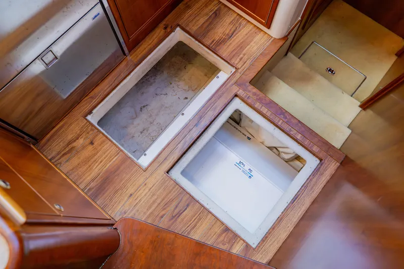 Slide: The Image of 2003 Wellcraft 400 Coastal interior with open floor storage compartments. - 109