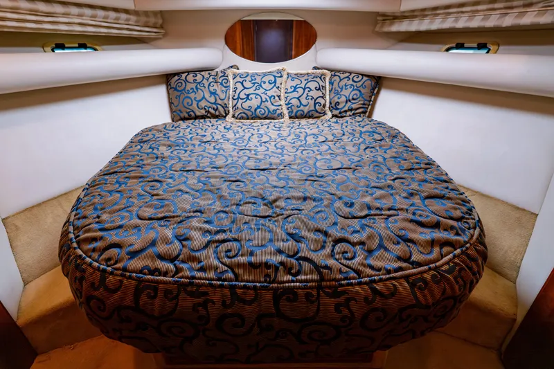Slide: The Image of Luxurious cabin interior of 2003 Wellcraft 400 Coastal yacht with patterned bedding. - 110