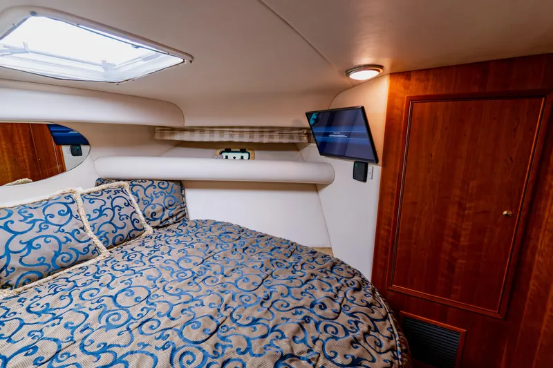 Slide: The Image of Luxurious cabin interior of 2003 Wellcraft 400 Coastal yacht with elegant bedding and wood accents. - 112