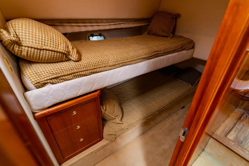 Slide: The Image of Interior cabin of 2003 Wellcraft 400 Coastal with bunk beds and wooden cabinetry. - 116