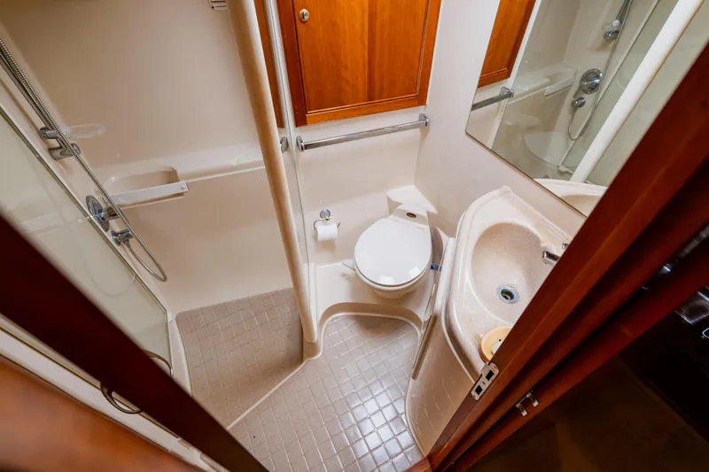 Slide: The Image of Bathroom interior of 2003 Wellcraft 400 Coastal yacht, featuring shower, toilet, and sink. - 121
