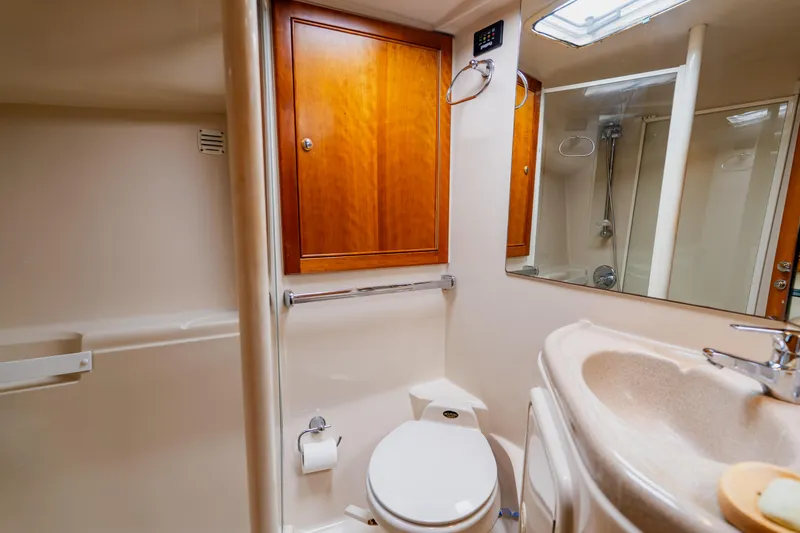 Slide: The Image of Bathroom interior of 2003 Wellcraft 400 Coastal yacht with wooden cabinets and modern fixtures. - 122