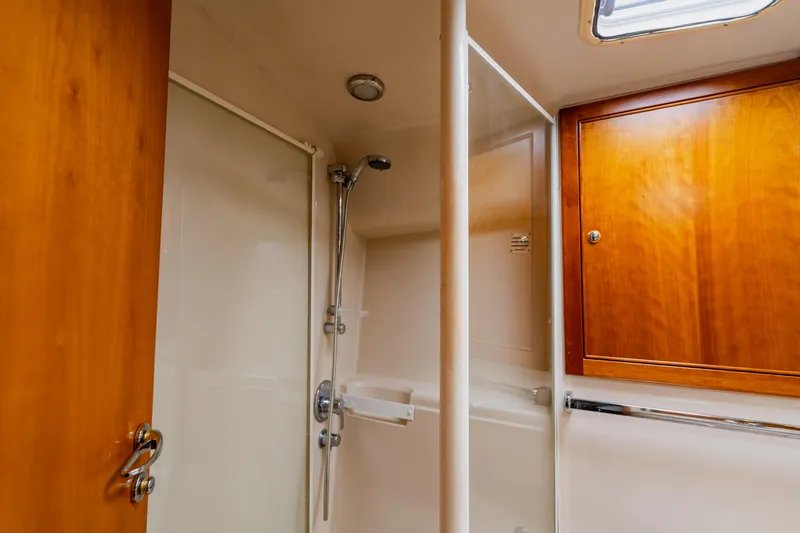 Slide: The Image of Bathroom interior of 2003 Wellcraft 400 Coastal yacht with wooden cabinetry and shower. - 123