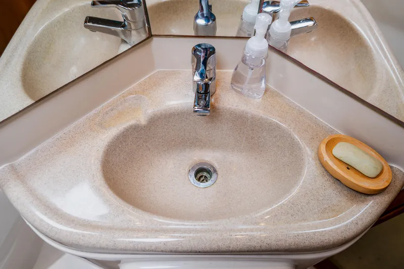Slide: The Image of Beige bathroom sink with chrome faucet and soap dish on Wellcraft 400 Coastal yacht. - 124
