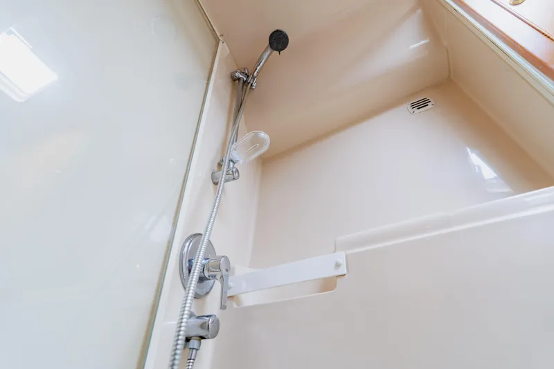 Slide: The Image of Shower area in 2003 Wellcraft 400 Coastal boat, featuring a handheld showerhead and sleek design. - 126