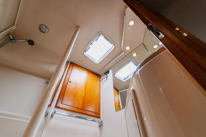 Slide: The Image of Interior of 2003 Wellcraft 400 Coastal yacht bathroom with wooden cabinet and skylight. - 127