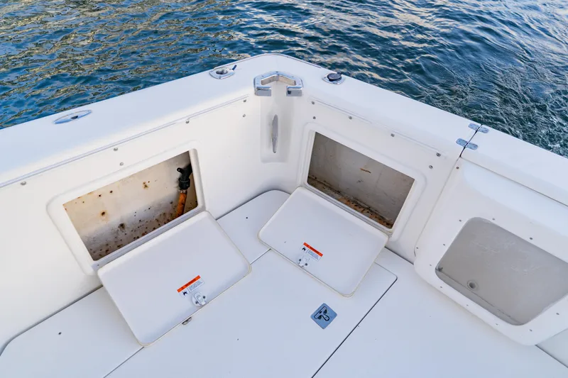 Slide: The Image of 2003 Wellcraft 400 Coastal boat deck with open storage compartments by the water. - 16