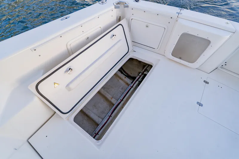 Slide: The Image of Open storage compartment on 2003 Wellcraft 400 Coastal boat deck, near water. - 17