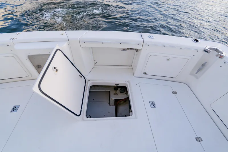 Slide: The Image of 2003 Wellcraft 400 Coastal boat deck with open hatch, showing storage compartment. - 18