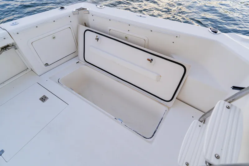 Slide: The Image of Open storage compartment on 2003 Wellcraft 400 Coastal boat deck by the water. - 20
