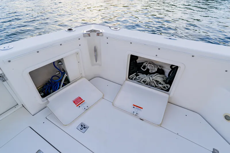 Slide: The Image of 2003 Wellcraft 400 Coastal boat deck with open storage compartments and coiled ropes. - 21