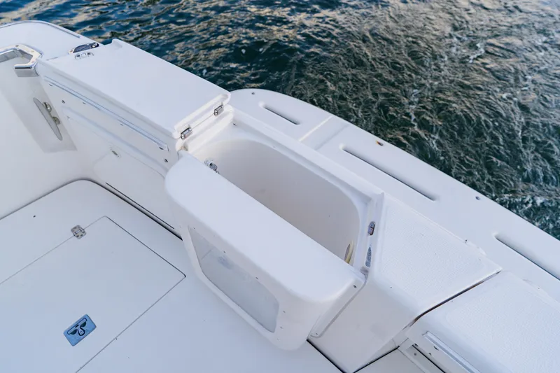 Slide: The Image of Open storage compartment on 2003 Wellcraft 400 Coastal boat deck by the water. - 22