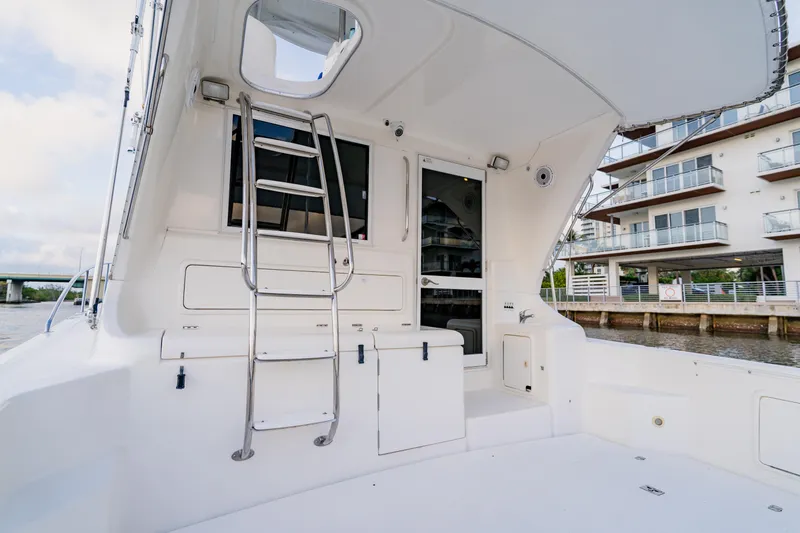 Slide: The Image of 2003 Wellcraft 400 Coastal yacht deck with ladder and waterfront view. - 24