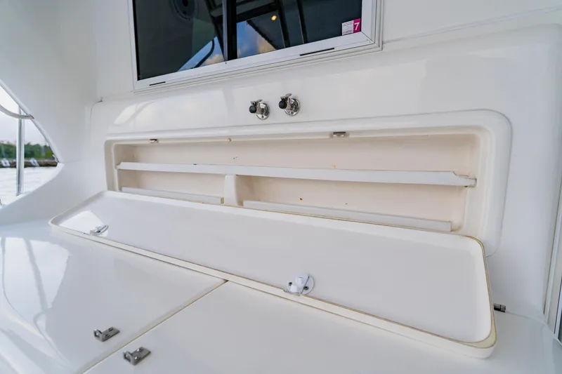 Slide: The Image of Storage compartment on a 2003 Wellcraft 400 Coastal boat, featuring sleek white design. - 26