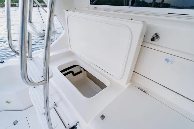Slide: The Image of Open storage compartment on 2003 Wellcraft 400 Coastal boat deck, near water. - 27