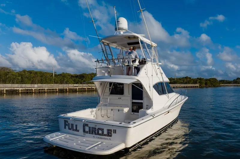 Slide: The Image of 2003 Wellcraft 400 Coastal yacht cruising on a sunny day, featuring a spacious deck. - 3