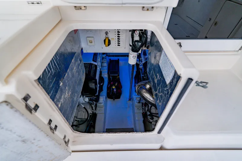 Slide: The Image of Engine compartment of 2003 Wellcraft 400 Coastal boat, featuring mechanical components and controls. - 31