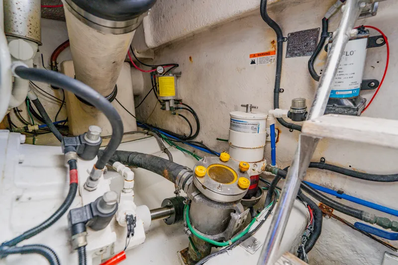 Slide: The Image of Engine room of 2003 Wellcraft 400 Coastal boat, showcasing mechanical components and wiring. - 35
