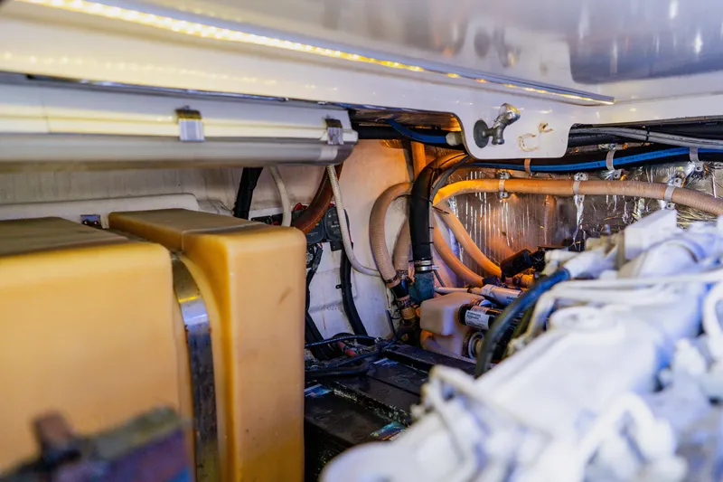 Slide: The Image of Engine room of 2003 Wellcraft 400 Coastal boat, showcasing mechanical components and wiring. - 38