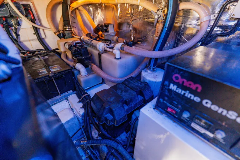 Slide: The Image of Engine room of 2003 Wellcraft 400 Coastal with Onan Marine Generator and complex piping system. - 40