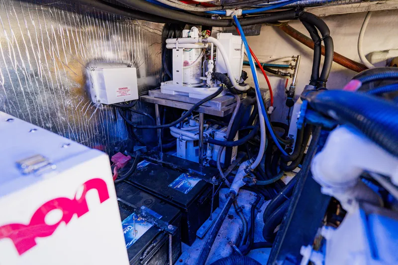 Slide: The Image of Engine room of a 2003 Wellcraft 400 Coastal boat, showcasing mechanical components and wiring. - 41