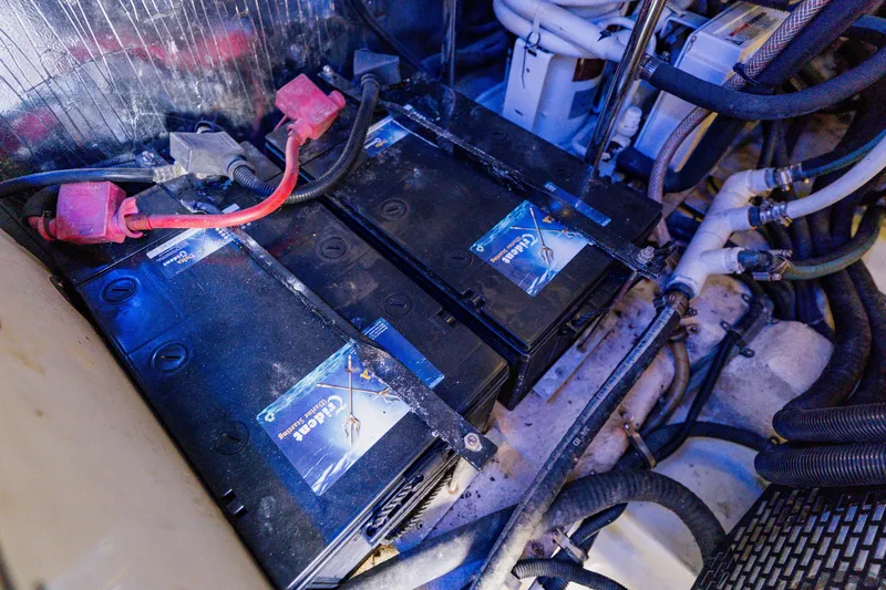 Slide: The Image of Batteries and wiring in the engine compartment of a 2003 Wellcraft 400 Coastal boat. - 42