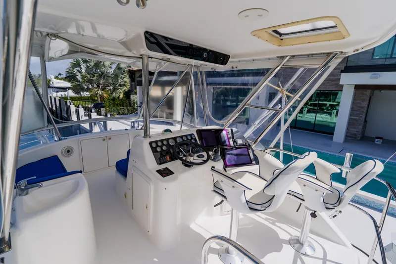 Slide: The Image of 2003 Wellcraft 400 Coastal boat cockpit with modern navigation equipment and seating. - 47