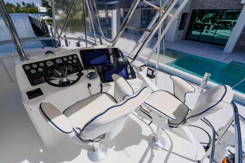 Slide: The Image of 2003 Wellcraft 400 Coastal boat helm with dual seats and modern navigation equipment. - 48