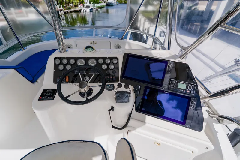 Slide: The Image of Cockpit of 2003 Wellcraft 400 Coastal boat with navigation instruments and steering wheel. - 49