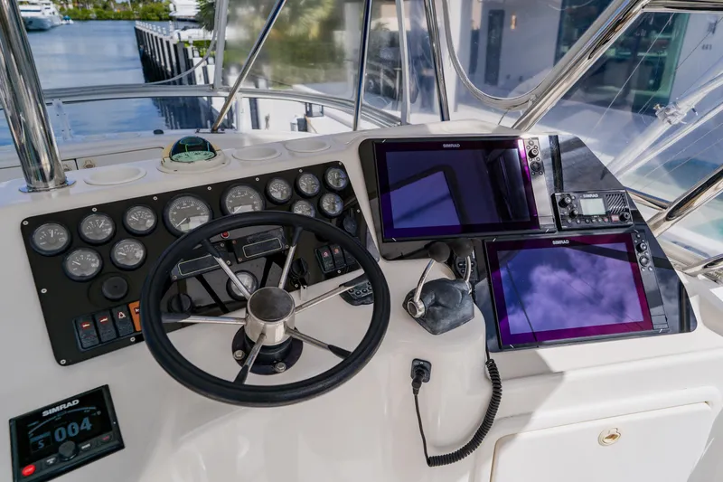 Slide: The Image of Control panel of a 2003 Wellcraft 400 Coastal boat with navigation screens and gauges. - 50
