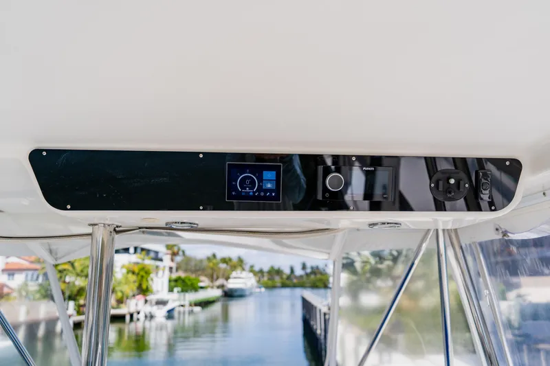 Slide: The Image of 2003 Wellcraft 400 Coastal boat dashboard with modern navigation controls and scenic waterway view. - 53