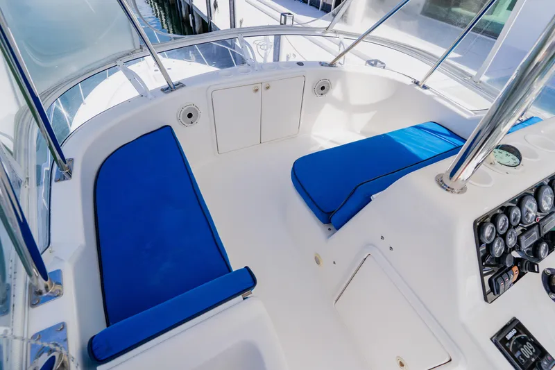 Slide: The Image of 2003 Wellcraft 400 Coastal boat cockpit with blue seating and control panel. - 54