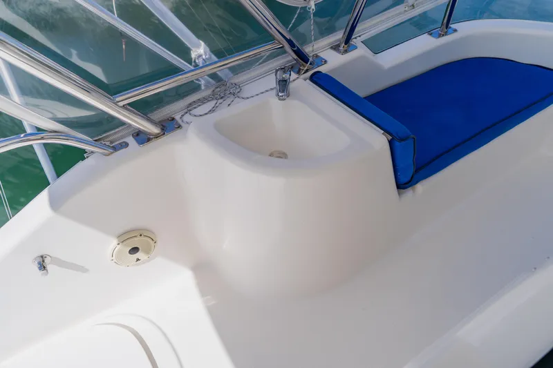 Slide: The Image of 2003 Wellcraft 400 Coastal boat interior with blue seating and white sink area. - 55