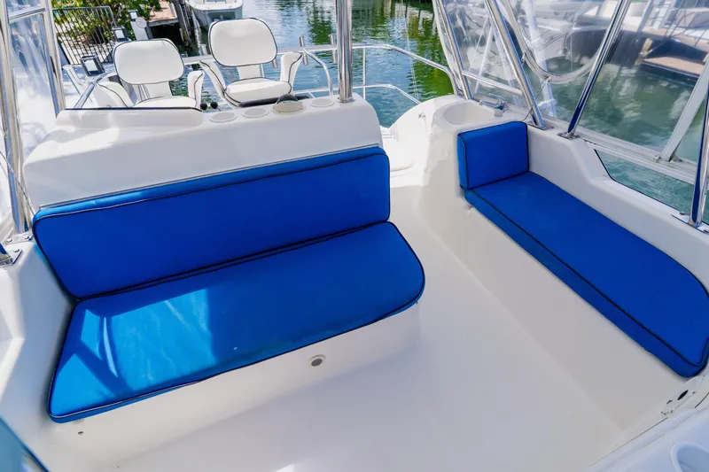 Slide: The Image of 2003 Wellcraft 400 Coastal boat interior with blue cushioned seating and white accents. - 58
