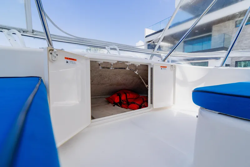 Slide: The Image of 2003 Wellcraft 400 Coastal boat interior with open storage compartment and life jackets. - 61
