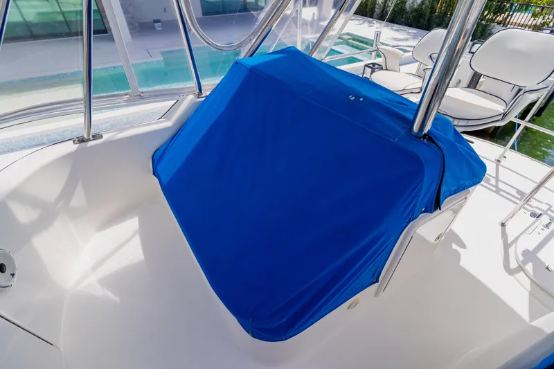 Slide: The Image of 2003 Wellcraft 400 Coastal boat interior with blue cover and seating area. - 67