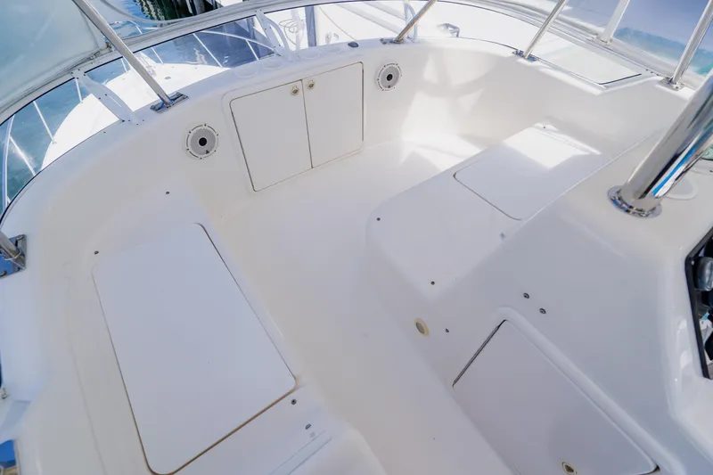 Slide: The Image of Spacious deck area of 2003 Wellcraft 400 Coastal boat, featuring white seating and storage compartments. - 68