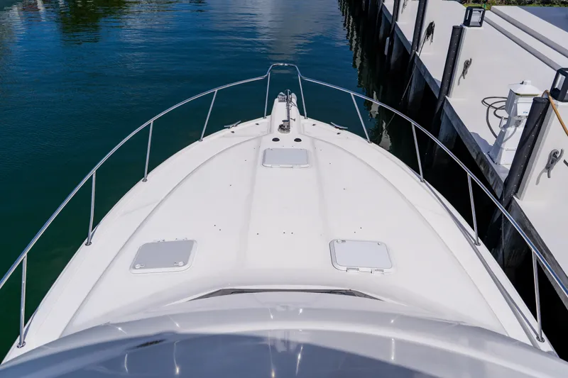 Slide: The Image of Bow view of 2003 Wellcraft 400 Coastal yacht docked at marina. - 69