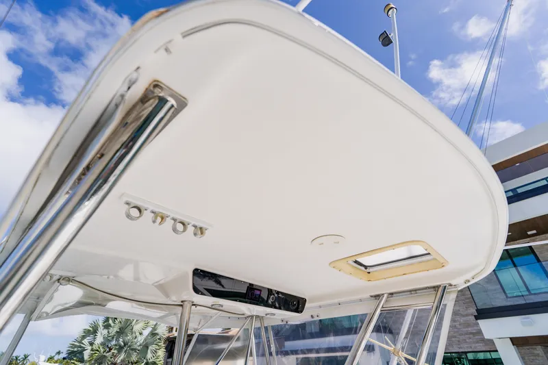 Slide: The Image of 2003 Wellcraft 400 Coastal boat canopy with stainless steel supports and clear sky background. - 70