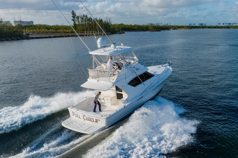 Slide: The Image of 2003 Wellcraft 400 Coastal yacht cruising on open water, creating a wake behind. - 8